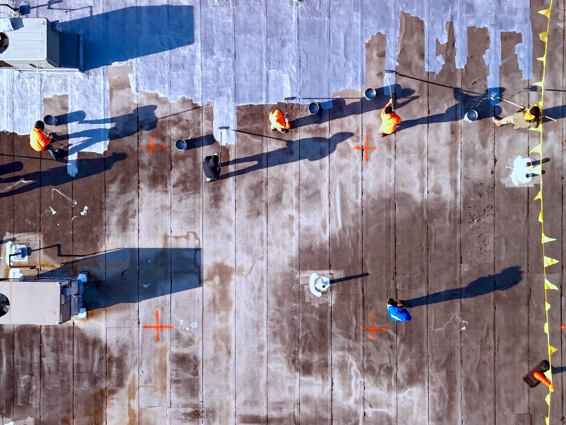 Deptford Shopping Center Deptford, NJ – AP-5100 Moisture Cure Polyurethane Base Coat Roll Application in Progress from Drone View Above Image of Deptford Shopping Center Deptford, NJ - AP-5100 Moisture Cure Polyurethane Base Coat Roll Application in Progress from Drone View Above