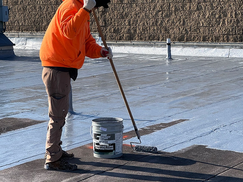 Deptford Shopping Center Deptford, NJ – AP-5100 Moisture Cure Polyurethane Roof Restoration Coating System Roller Application Up Close Roof Level Image of Deptford Shopping Center Deptford, NJ - AP-5100 Moisture Cure Polyurethane Roof Restoration Coating System Roller Application Up Close Roof Level